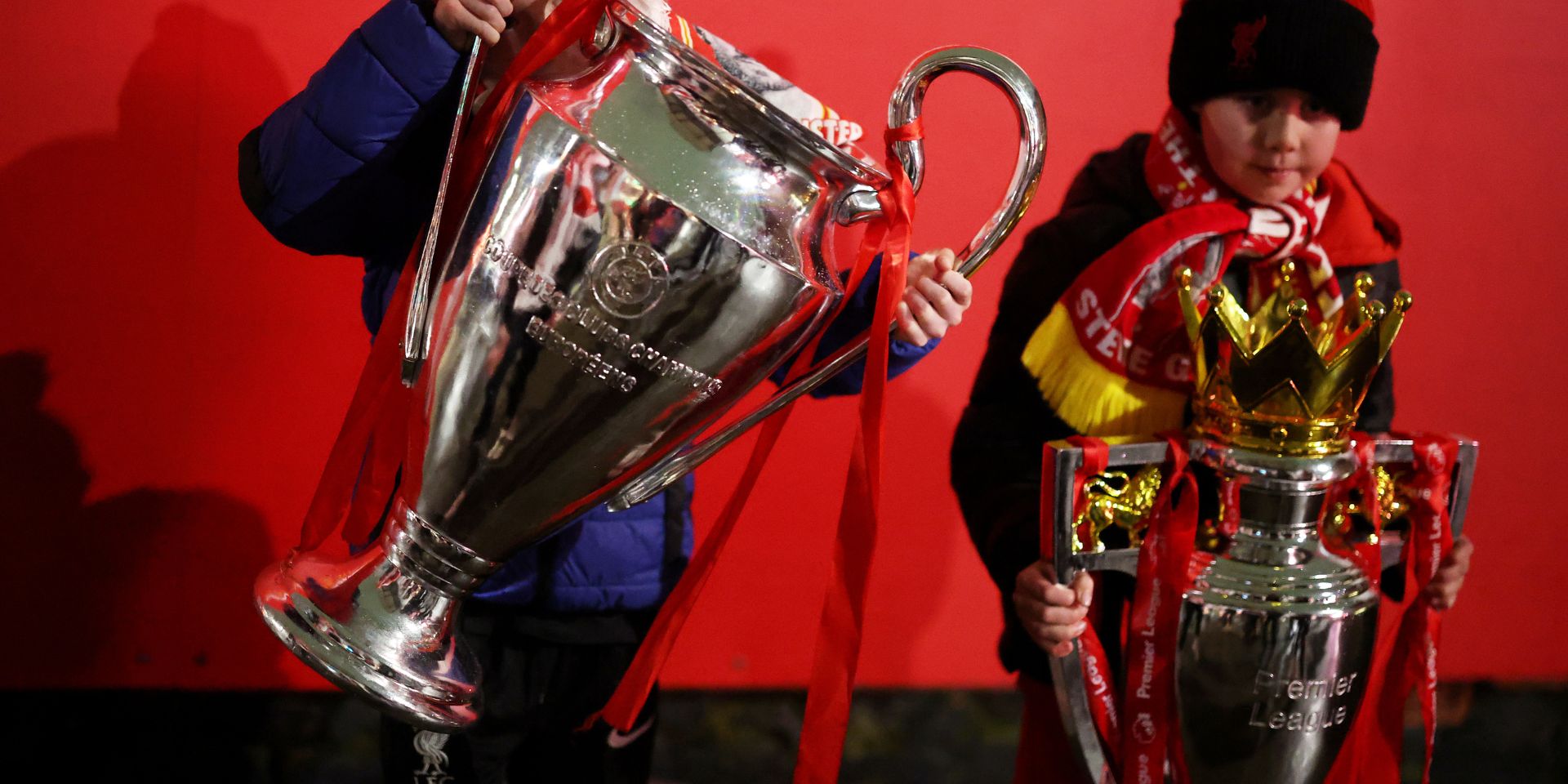 Liverpool fans with the Premier League and Champions League trophy