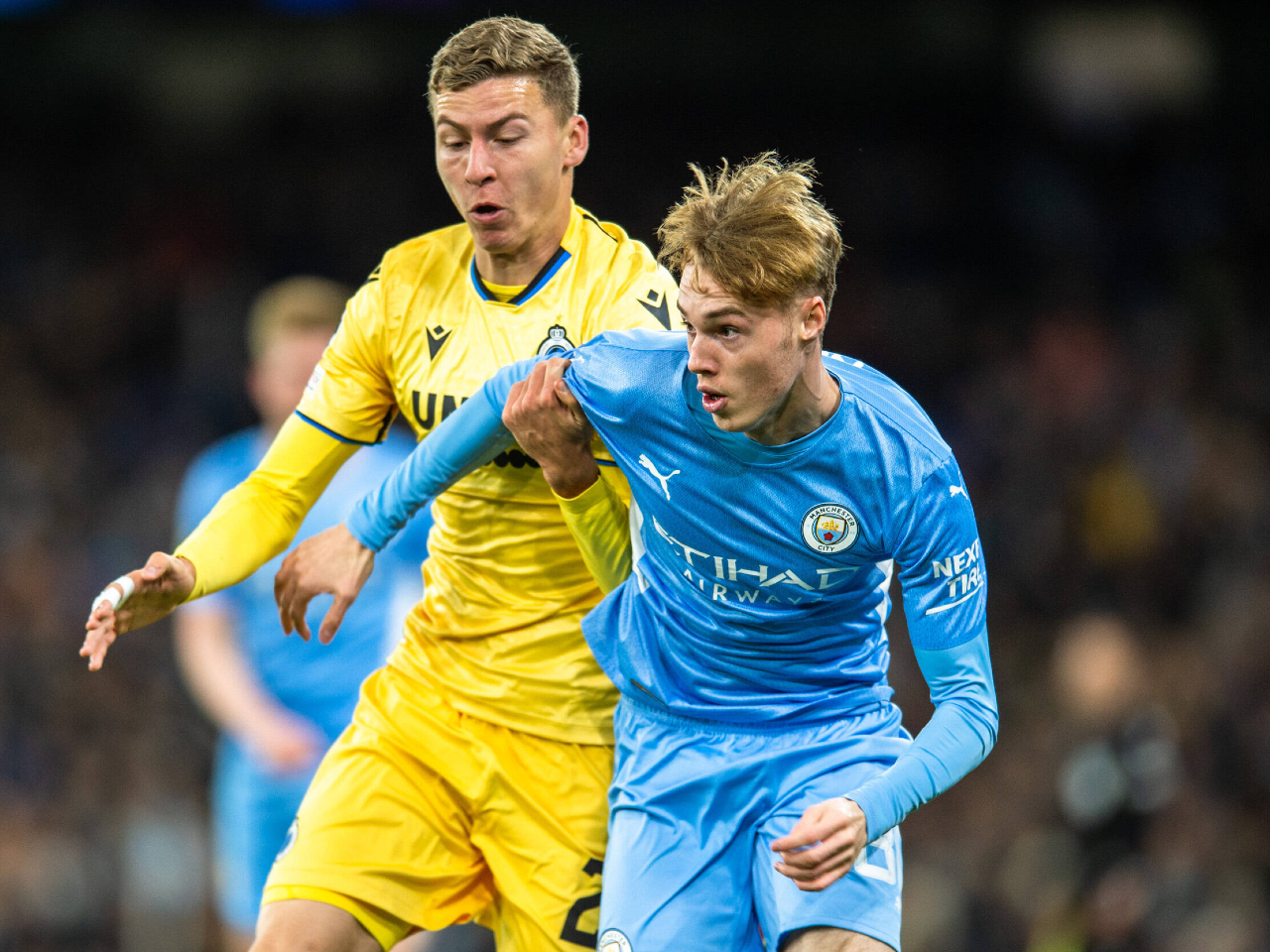 Cole Palmer of Manchester City holds off Ignace Van Der Brempt of Club Brugge on November 3, 2021