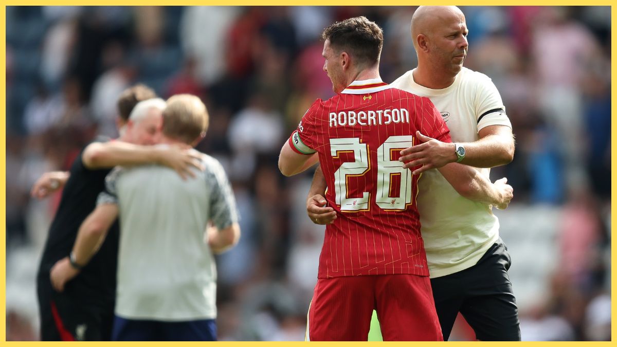 Andy Robertson hugs Liverpool head coach Arne Slot.