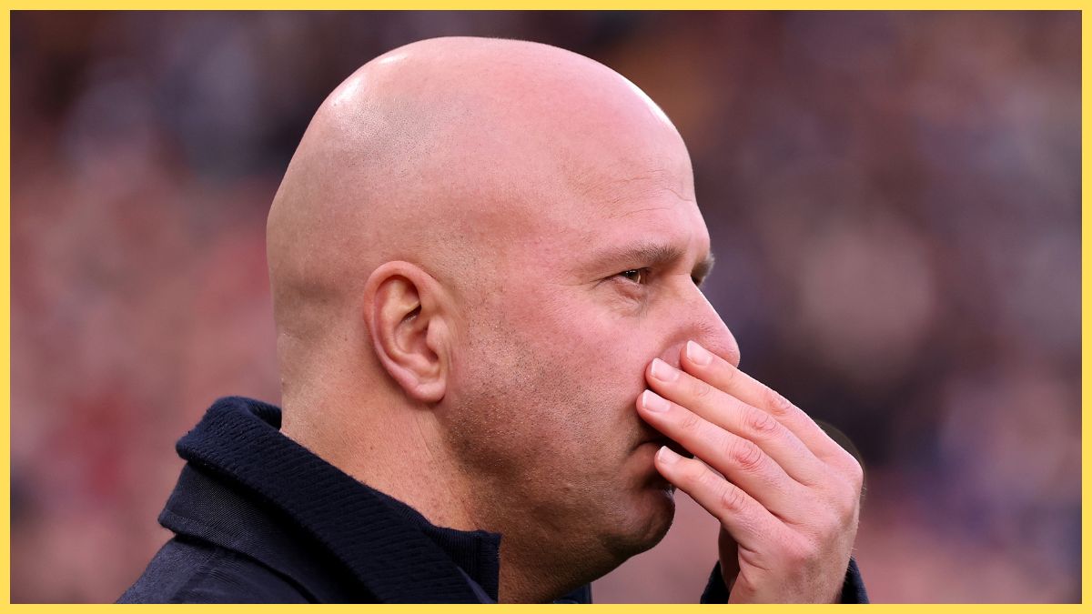 Arne Slot pinches his nose.