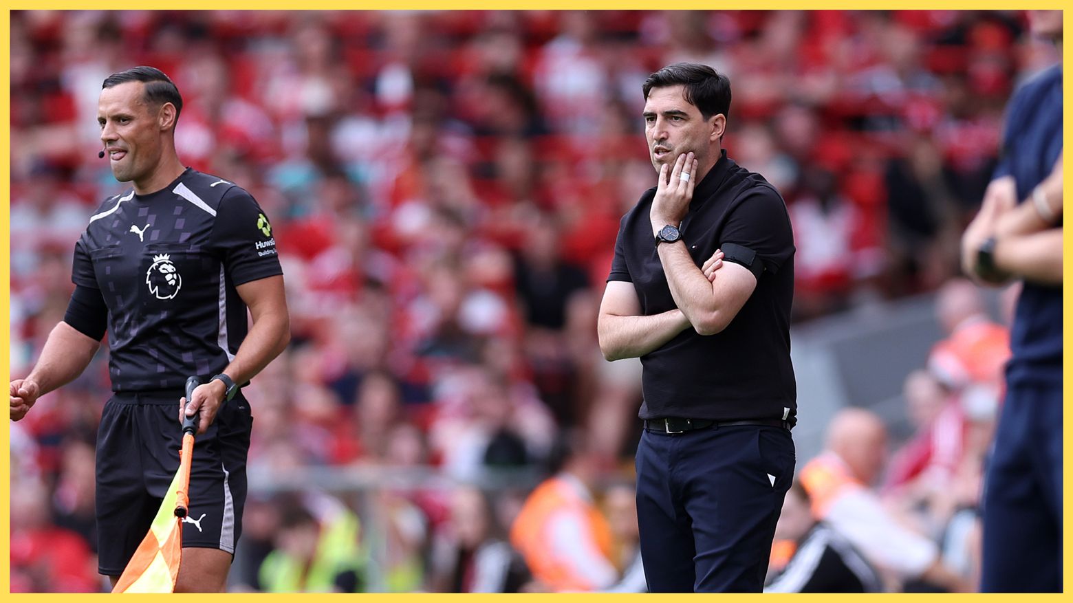 Liverpool manager Andoni Iraola looks concerned while watching his team from the touchline.