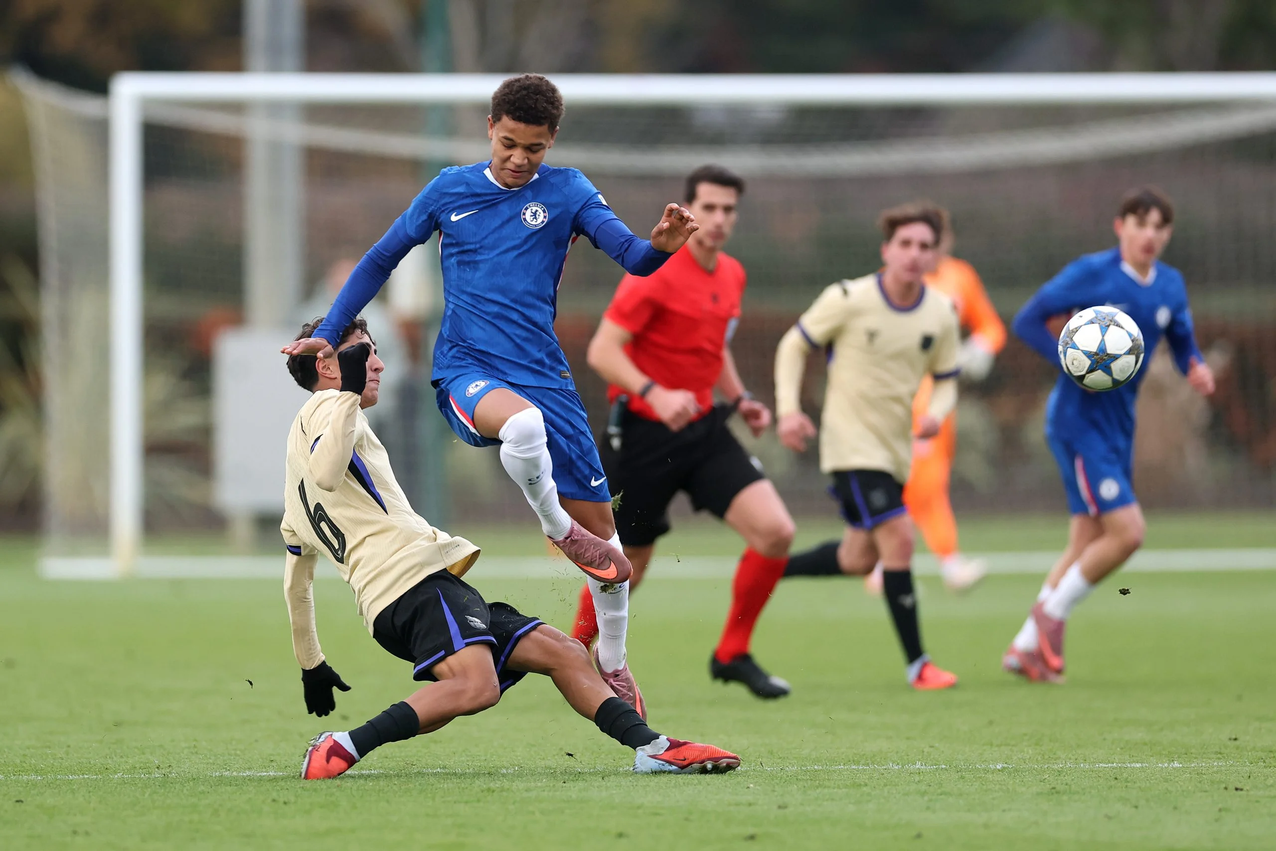 Mahdi Nicoll-Jazuli of Chelsea is challenged by Pedro Villar of FC Barcelona