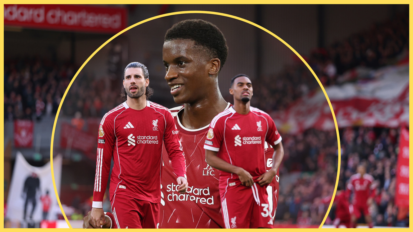 Liverpool midfielders Dominik Szboszlai and Ryan Gravenberch walk in front of a smiling Trey Nyoni.