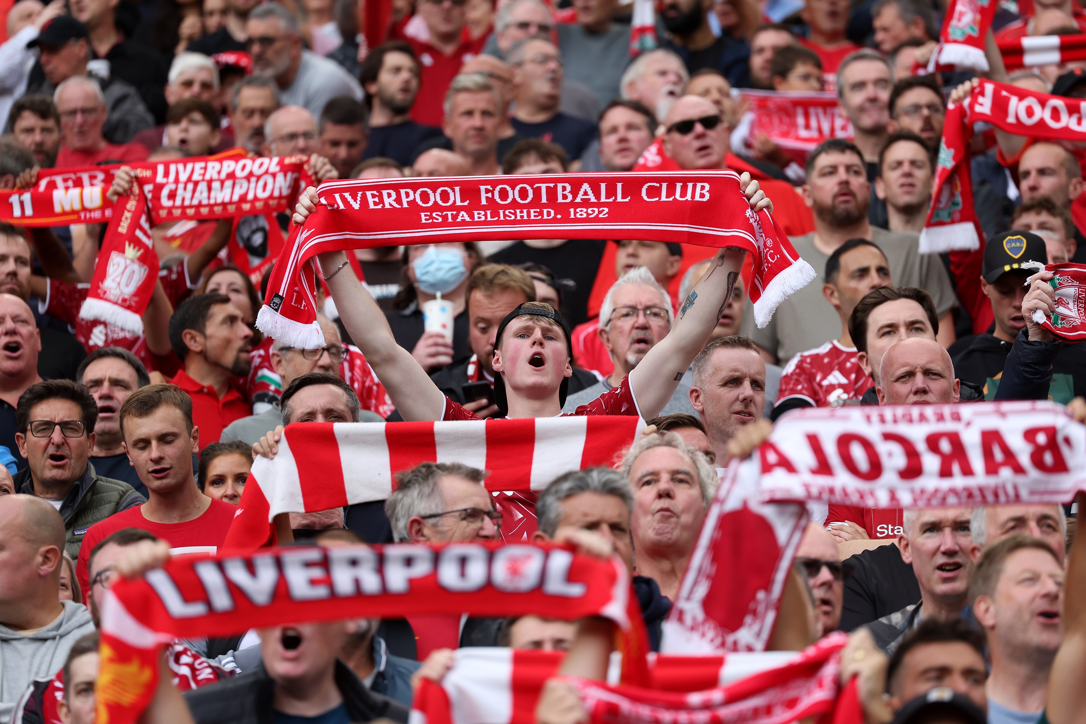 Les fans de Liverpool brandissent des foulards rouges à Anfield.